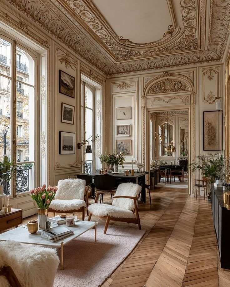Elegant Parisian-style living room with ornate ceilings, large windows, cozy chairs, and chic decor. Perfect blend of classic and modern.