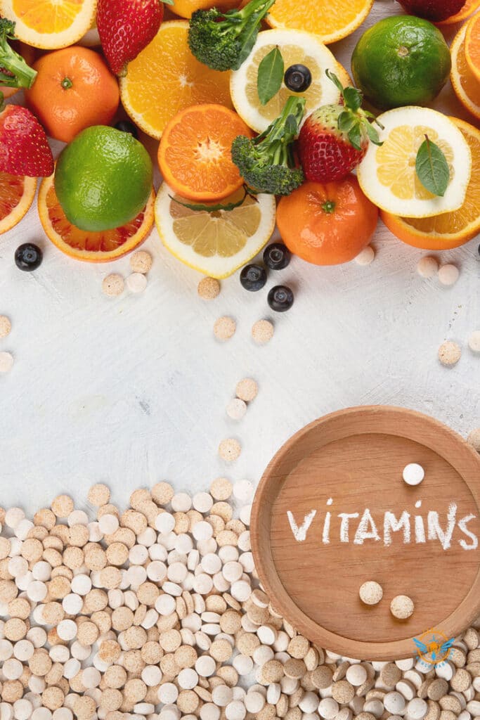 Fresh fruits and vitamin tablets on a table, emphasizing health and nutrition benefits.