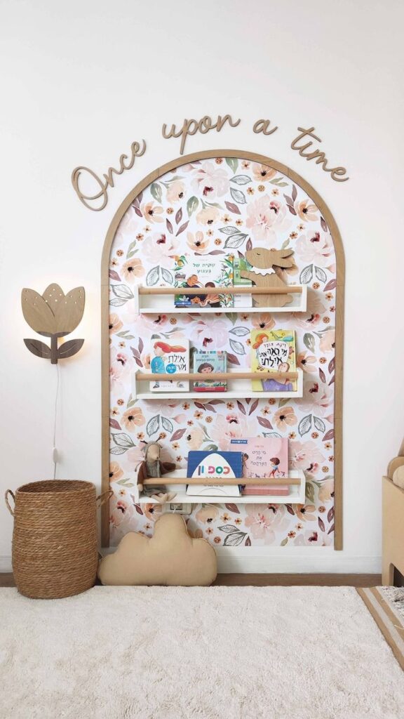 Whimsical kids' reading nook with floral backdrop, bookshelves, and Once upon a time decor. Cozy, inviting space for storytime.