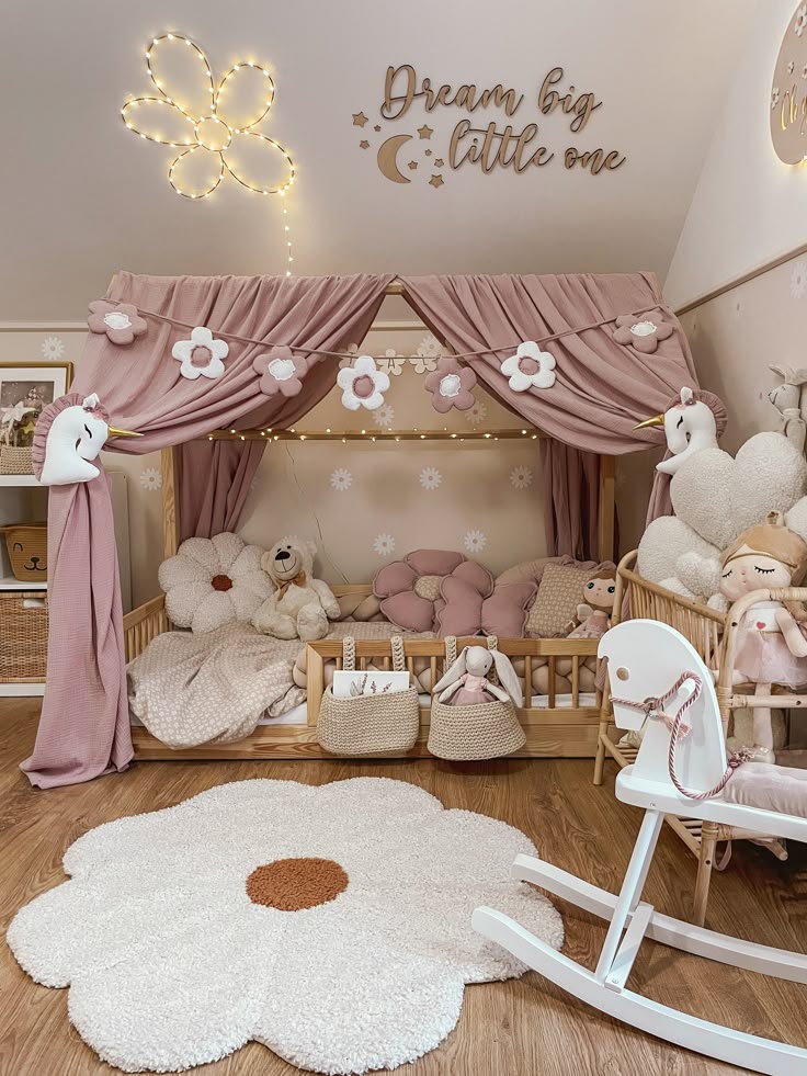 Cozy pink and white nursery with floral decor, plush toys, and a canopy bed, perfect for a dreamy and elegant baby room.