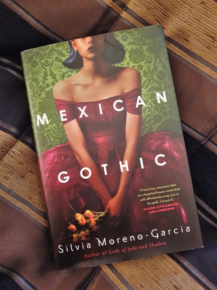 Cover of Mexican Gothic by Silvia Moreno-Garcia featuring a woman in a red dress on a patterned green background.