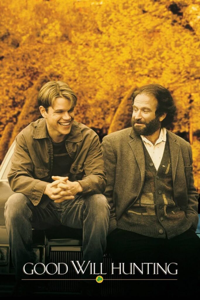Two men share a heartfelt moment in an autumn setting, promoting the movie Good Will Hunting with a backdrop of golden leaves.