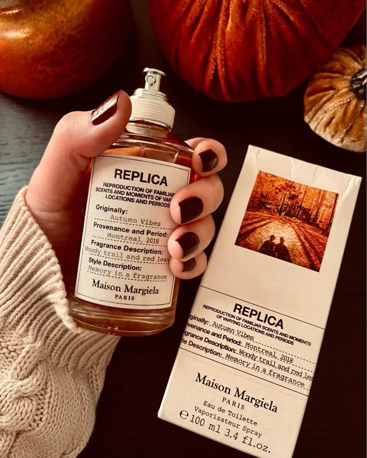 Maison Margiela Replica Autumn Vibes perfume with box, depicting a cozy autumn scene. Warm and woody scent for seasonal ambiance.