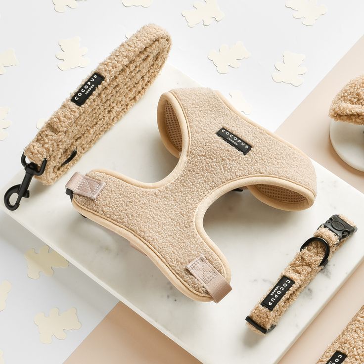 Cozy beige dog accessories set: harness, leash, and collar on marble surface, perfect for stylish pets.