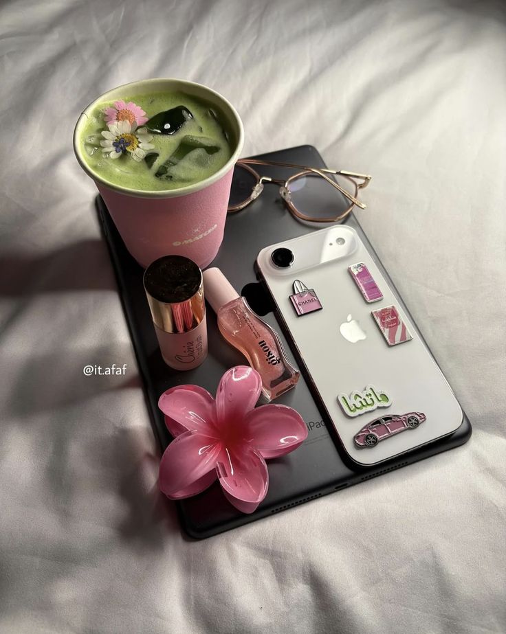 Screenshot - Handy Home Stylish flat lay with matcha latte, pink accessories, glasses, and a decorated phone on a tablet. Cozy and trendy vibes.