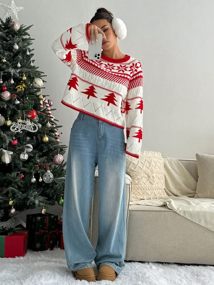 1pc Women Casual Everyday Christmas Tree Pattern Crew Neck Sweater Autumn_Winter ClothesLong Sleeve Tops Knit Pullover Fall Outfit - Handy Home Woman in festive sweater, jeans, and earmuffs taking a selfie by a decorated Christmas tree, cozy holiday home setting.