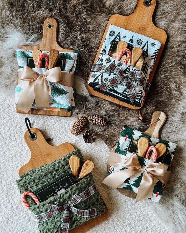 Festive gift sets on cutting boards with cozy towels, wooden spoons, candy canes, and ribbon, perfect for holiday presents.