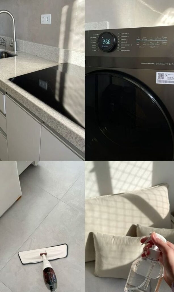 Bright kitchen and laundry room with countertop, sleek appliances, mop on tile floor, and cleaning spray by cushions. Cozy, tidy space.