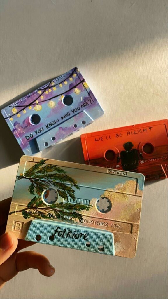 Hand-painted cassette tapes with unique designs and messages: Do you know who you are? and We'll be alright.