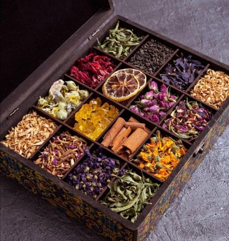 Box of assorted dried herbs and spices, featuring colorful floral and citrus selections, perfect for cooking or decoration.