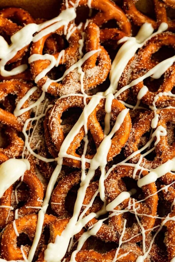 Cinnamon Sugar Pretzels with 4 Ingredients + Video - Handy Home Close-up of cinnamon sugar pretzels drizzled with white chocolate, creating a tasty snack perfect for indulgence.