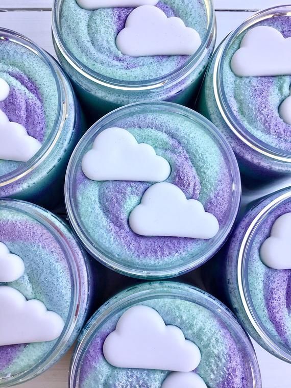 Colorful whipped soap jars with cloud designs, featuring purple and teal swirls. Ideal for skincare and bath indulgence.