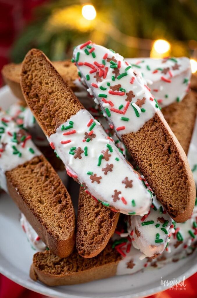 Delicious and Festive Gingerbread Biscotti gingerbread biscotti recipe coffee christmas - Handy Home Festive biscotti with white icing and colorful sprinkles, perfect for holiday treats and Christmas celebrations.