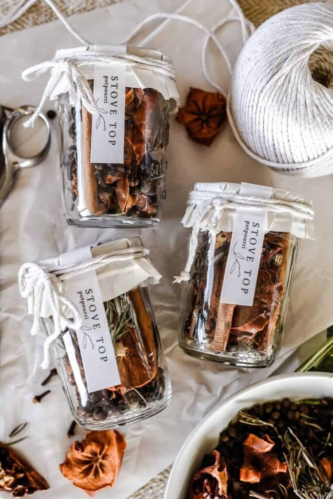 Jars of homemade stovetop potpourri with dried spices, perfect for adding a cozy aroma to your home.
