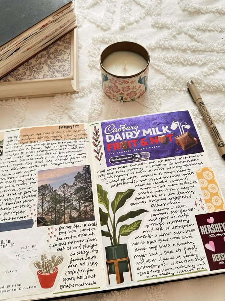 Open journal with handwritten notes, a chocolate wrapper, and candle on a cozy table. Creative writing and journaling concept.