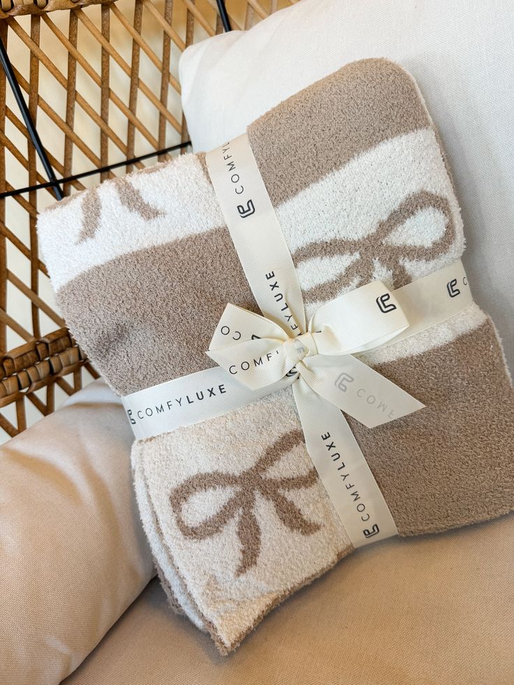 Cozy knit blanket with ribbon pattern, presented with elegant ComfyLuxe branding, ideal for a luxurious home decor touch.