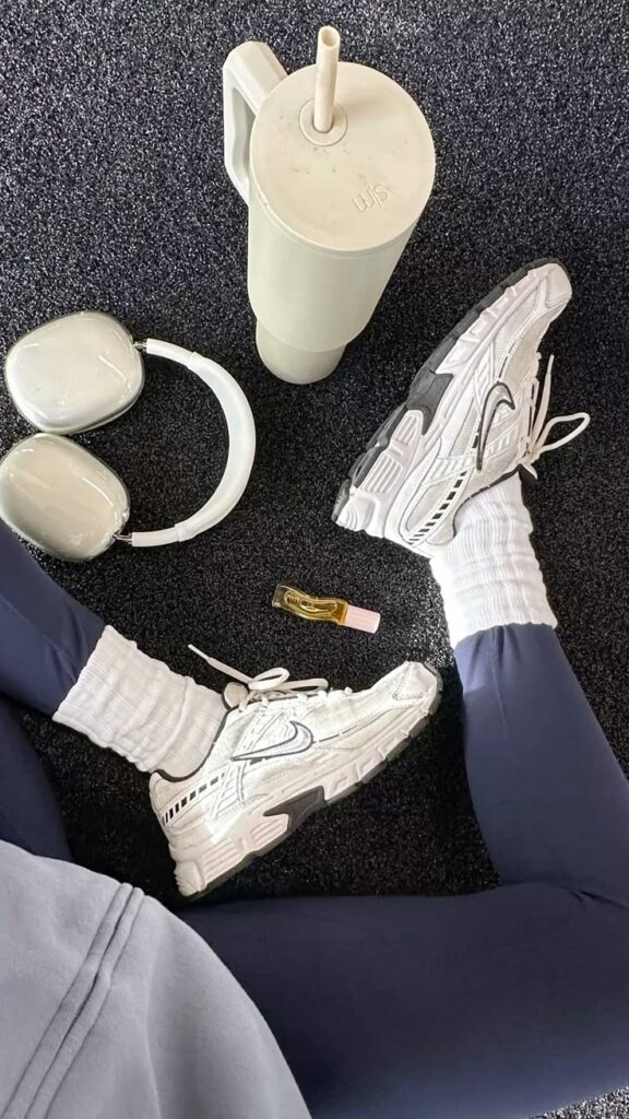 Workout morning 🤤 - Handy Home Workout essentials: white sneakers, headphones, water bottle, perfume, and leggings on a black carpet. Perfect gym gear setup.