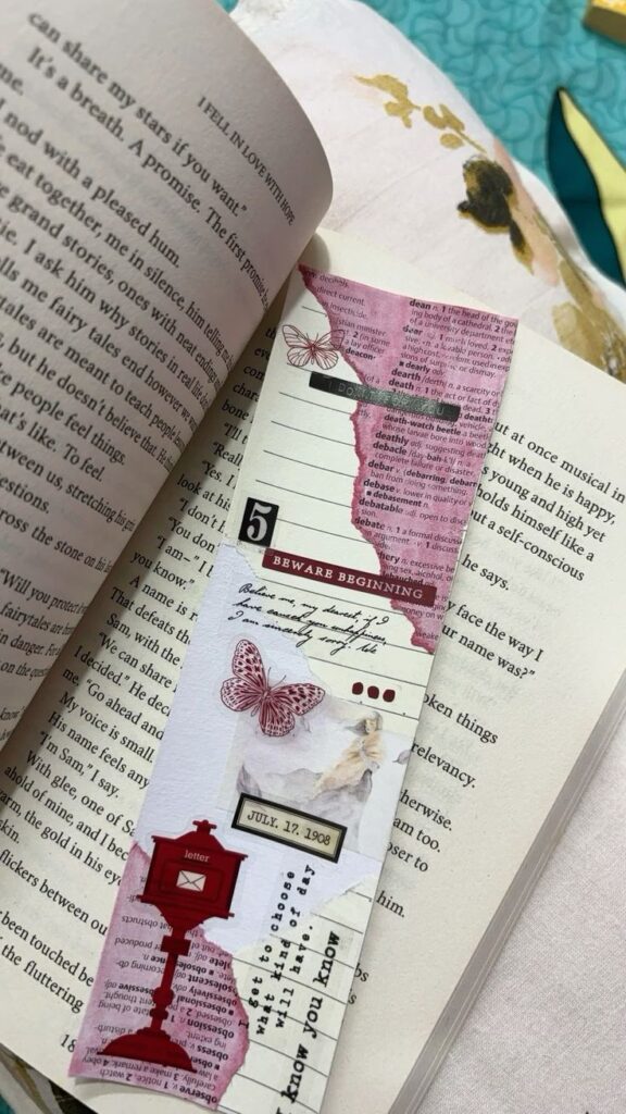 Open book with a decorative bookmark featuring butterflies, text clippings, and vintage designs. Perfect for book lovers.