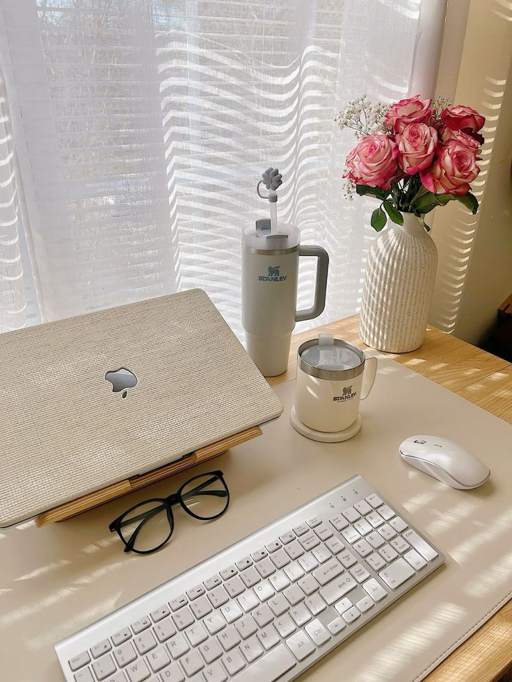 undefined 5 - Handy Home Elegant home office desk setup with a laptop, keyboard, glasses, mouse, floral vase, and beverage tumbler in natural light.