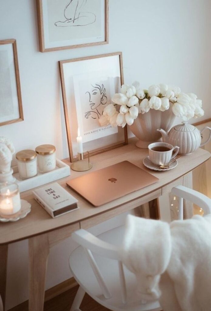 xfgbnzdb - Handy Home Cozy home office with laptop, tea, candles, and tulips on a wooden desk. Minimalist decor and artwork create a relaxing workspace.