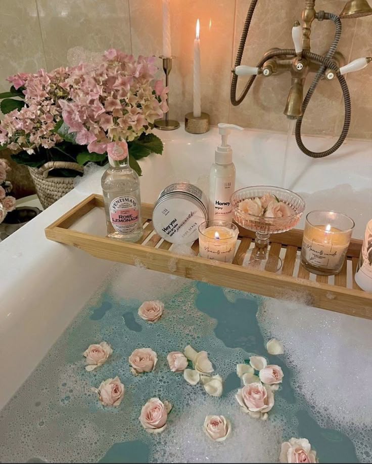 1df1f6cc-c25f-4d31-bc33-af1f26c3085d - Handy Home Luxurious bath setup with rose petals, candles, and bath products on a wooden tray, creating a serene spa-like atmosphere.