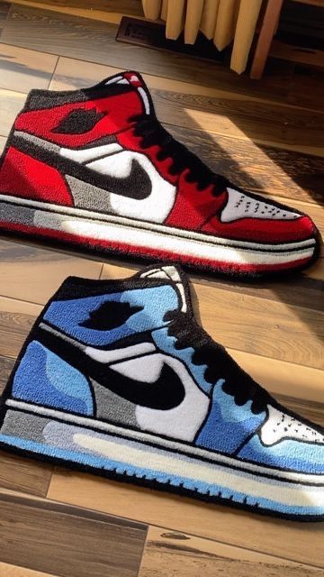 Colorful sneaker-inspired rugs in red and blue, designed with Nike-like swoosh patterns, displayed on a wooden floor.