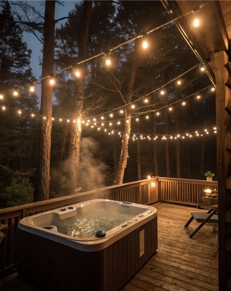Screenshot Outdoor hot tub on a wooden deck, surrounded by string lights at dusk, creating a cozy, inviting atmosphere in a forest setting. - Handy Home Outdoor hot tub on a wooden deck, surrounded by string lights at dusk, creating a cozy, inviting atmosphere in a forest setting.