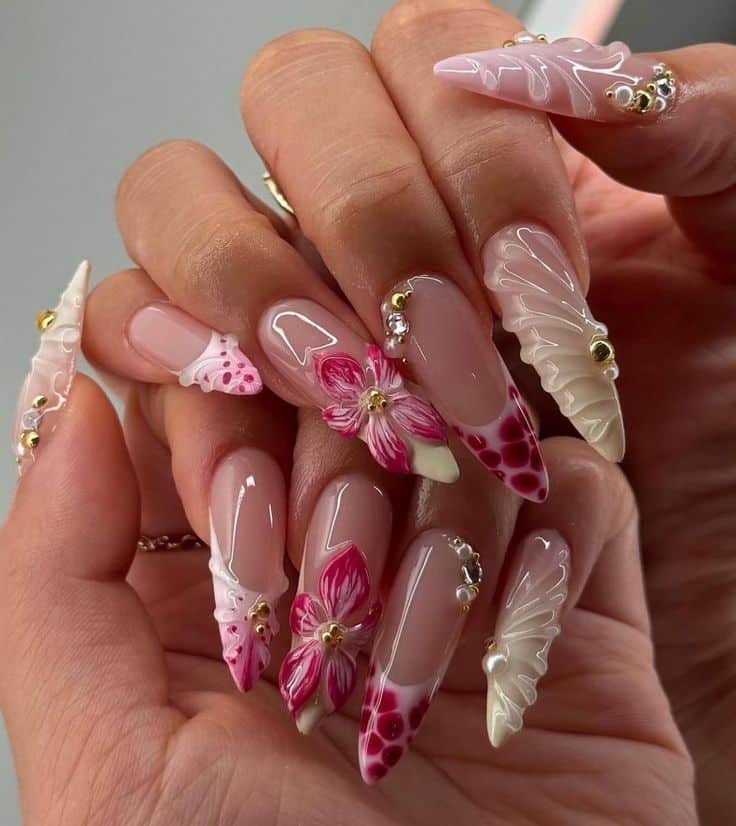85b60c18-0a00-4e95-8591-f1fb390afce1 - Handy Home Intricate 3D floral nail art with pink and white designs, featuring rhinestones and gold details on long almond-shaped nails.