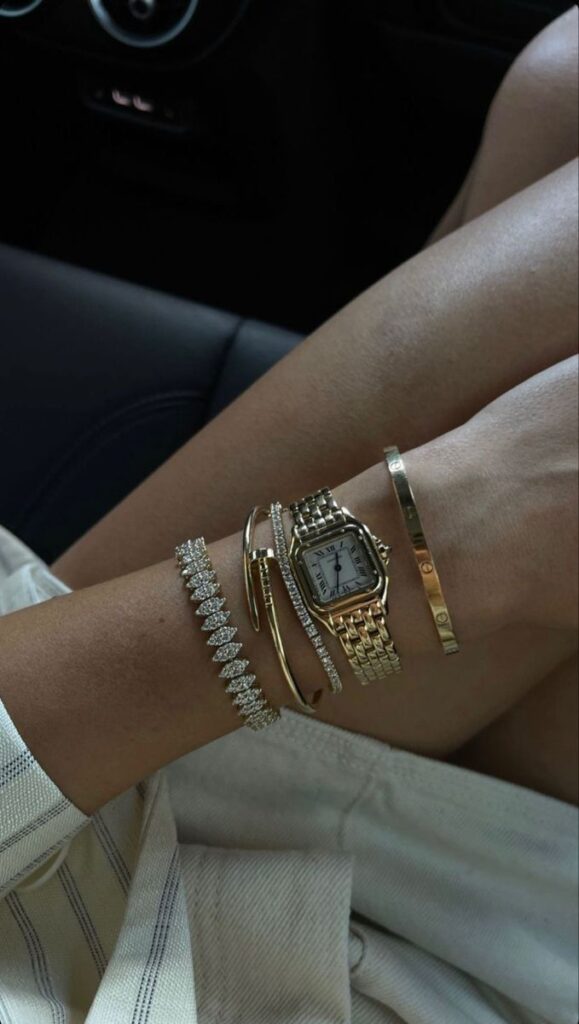 Everyday jewelry - Handy Home Elegant wrist adorned with luxury gold watch and diamond bracelets, showcasing style and sophistication.