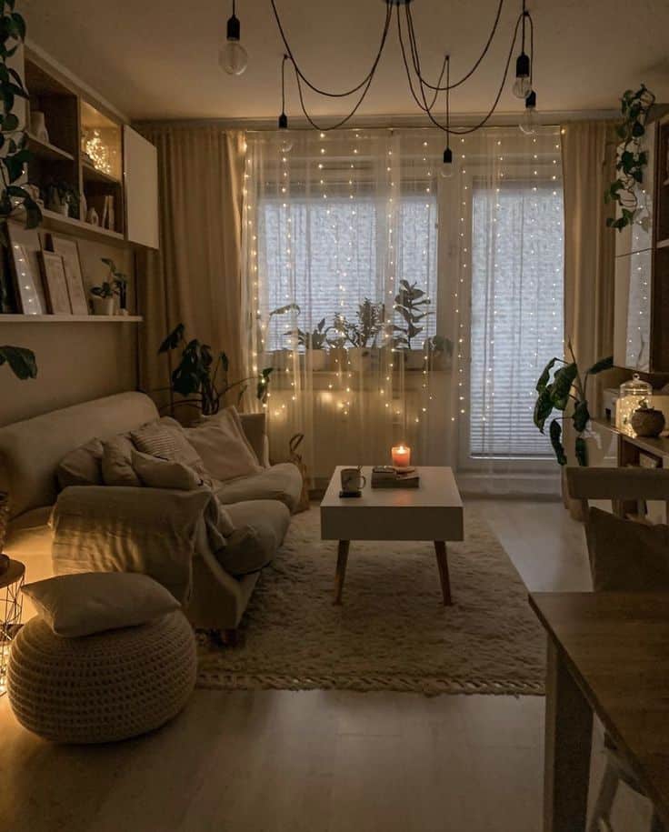 Home Decor Interior Design Organized Home Decor Western 301225 - Handy Home Cozy living room with ambient lighting, beige sofa, string lights, plants, wooden table, and candles, creating a warm, inviting atmosphere.