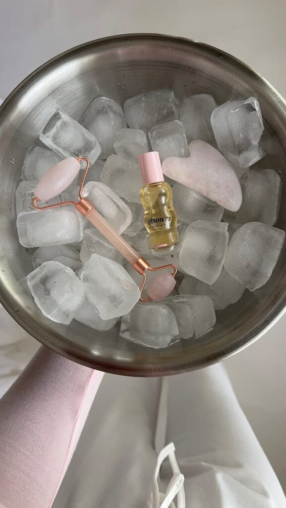 Icy Glow Self-Care Ritual - Handy Home Beauty tools on ice: facial roller, gua sha, and oil for skincare routine cooling, enhancing glow and relaxation.
