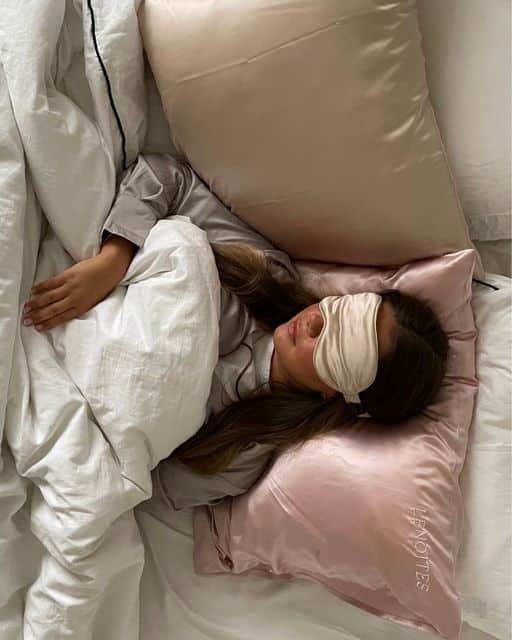 LENOITES on Instagram_ _Dont disturb - Im having - Handy Home Woman sleeping with eye mask on pink satin pillow and white bedding, promoting restful sleep and relaxation.