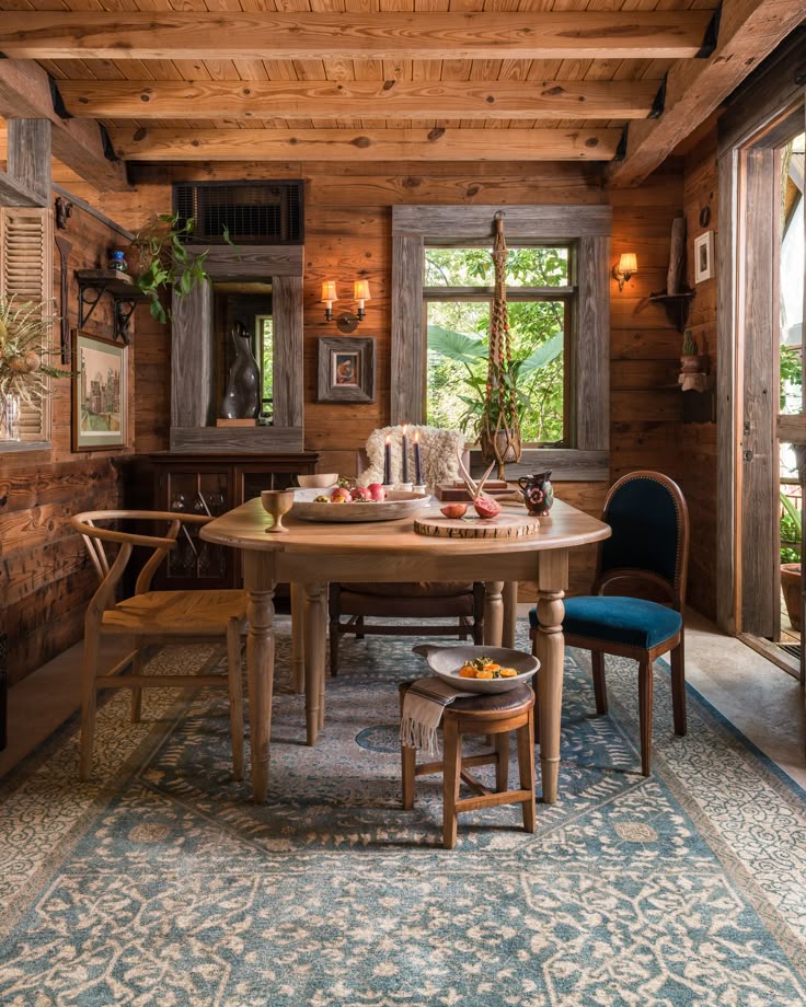 LOLOI Century I Rug - Blue Sand - 28__ X 106__ Cozy rustic dining room with wooden walls, vintage chairs, a round table, and natural light through windows, creating a warm ambiance. - Handy Home Cozy rustic dining room with wooden walls, vintage chairs, a round table, and natural light through windows, creating a warm ambiance.