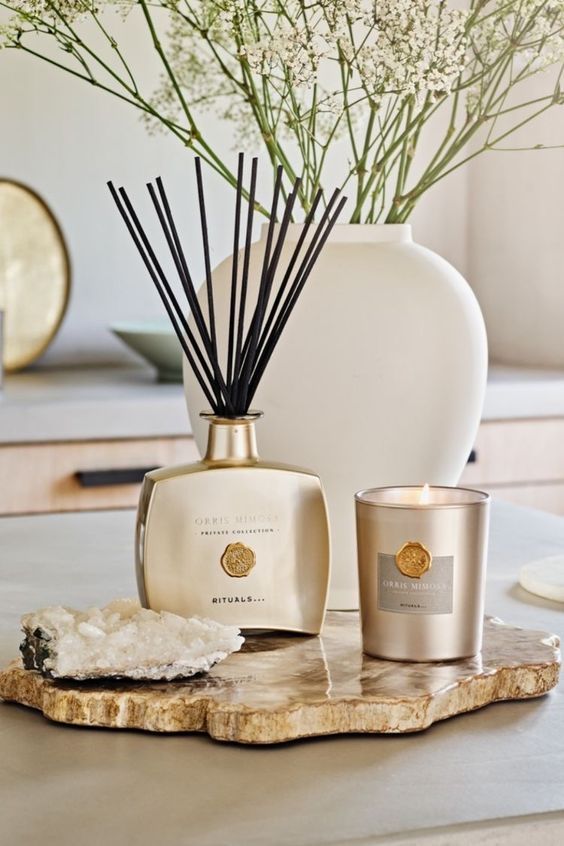 Miss Paty - Handy Home Luxury home aromatherapy setup with a reed diffuser, candle, and white vase on a stone tray. Elegant scent decor for relaxation.