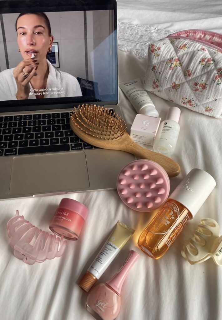 Skincare girly cozy at home 🎀🌸🍯 - Handy Home Beauty products and laptop on bed, skincare routine with a video tutorial playing, wooden brush, and floral makeup bag.