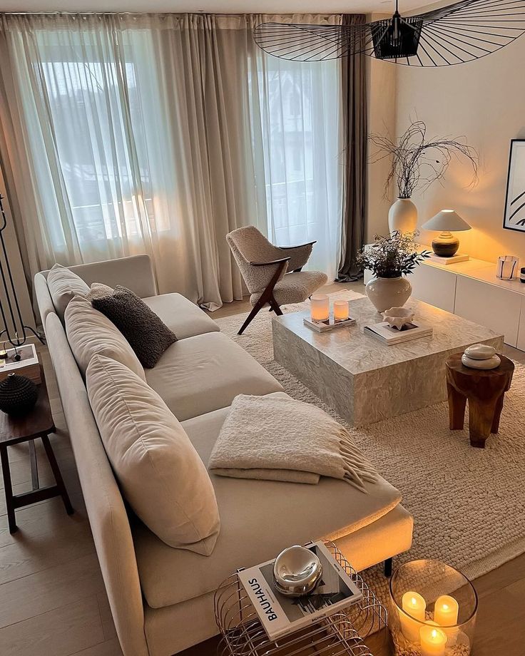 f6bbb790-8a22-45af-9940-e3cb3215d5a6 - Handy Home Modern living room with beige sofa, marble coffee table, cozy lighting, and stylish decor. Neutral tones and elegant ambiance.