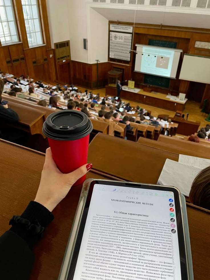 msu lecture study aesthetic autumn nails - Handy Home Student in lecture hall with tablet on chemistry and red coffee cup, observing presentation at the front of the class.