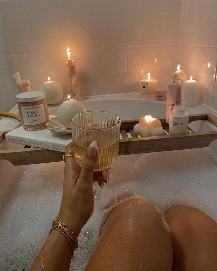 self care aesthetic - Handy Home Relaxing bath with candles and wine; a cozy, self-care moment with skincare products and a book.