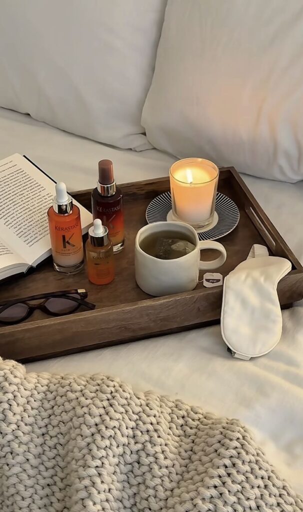 Screenshot - Handy Home Cozy bedroom setup with a tray of skincare products, candle, tea, and a book, perfect for relaxation and self-care.