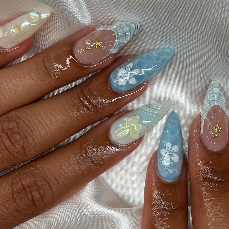 𓆩♡𓆪 - Handy Home Elegant nail art with blue and white floral designs on glossy, almond-shaped nails. Perfect for a stylish, modern look.
