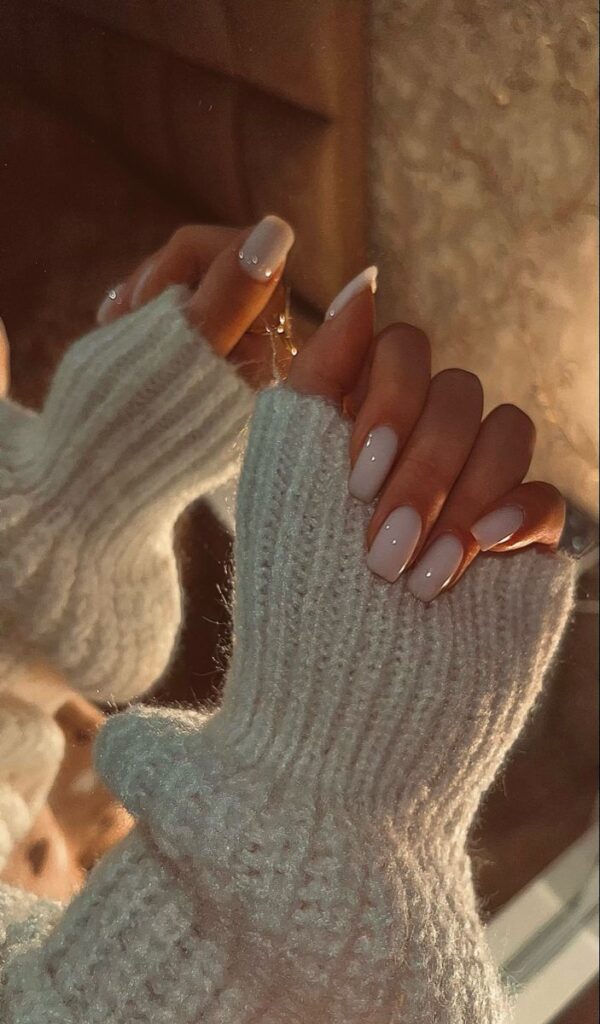 🤍✨ - Handy Home Cozy vibes with elegant, glossy nude nails and a soft white sweater, perfect for a warm winter aesthetic.