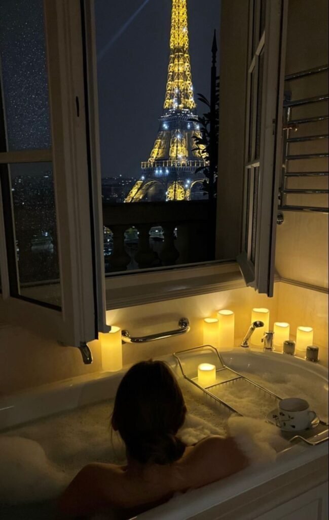 Cozy bubble bath with Eiffel Tower view, surrounded by candlelight, offering a romantic and serene Parisian ambiance.