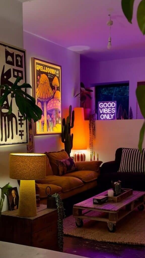 Cozy living room with vibrant lighting, neon sign, and eclectic decor for a relaxing, bohemian vibe.