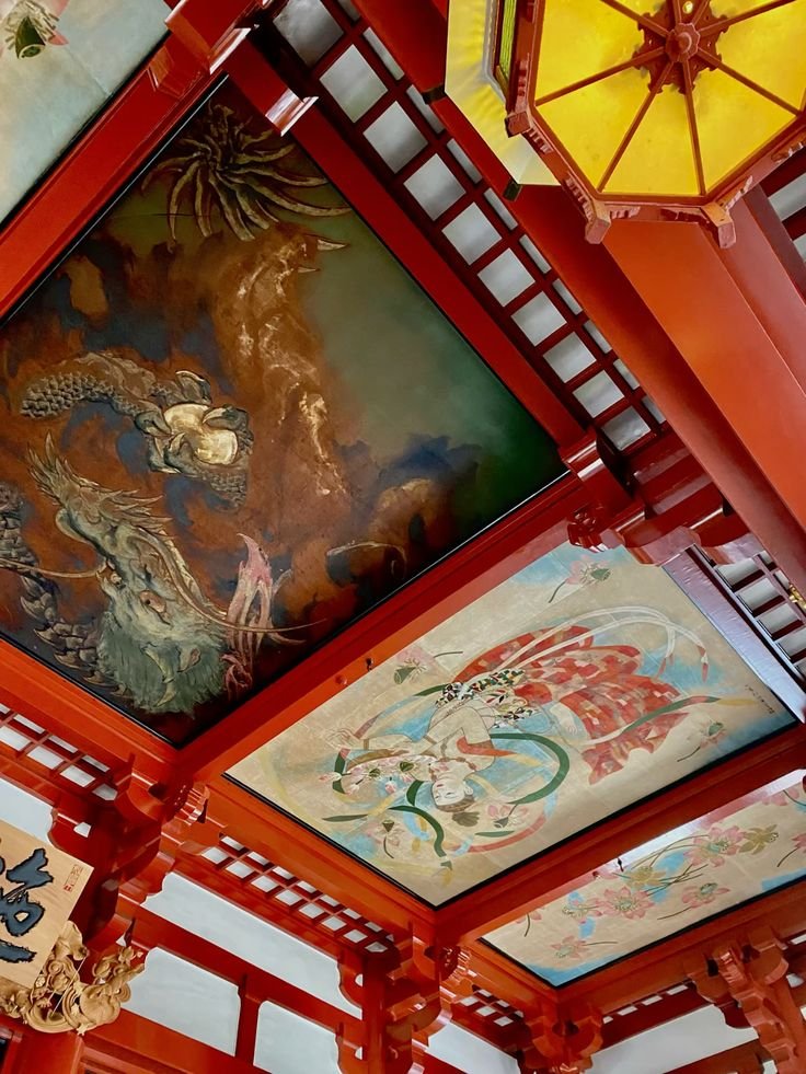 Ornate temple ceiling with intricate dragon and mythical art, vibrant reds and yellows, showcasing traditional Asian craftsmanship.