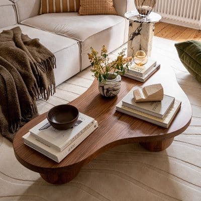 Bkoksety Solid wood retro style creative simple tea table _ Wayfair Stylish wood coffee table with books, decor, and plants in a cozy living room setting. Warm tones and modern design. - Handy Home Stylish wood coffee table with books, decor, and plants in a cozy living room setting. Warm tones and modern design.