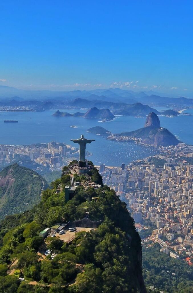 Iconic Christ the Redeemer statue overlooks Rio de Janeiro with stunning bay and cityscape views on a clear day.