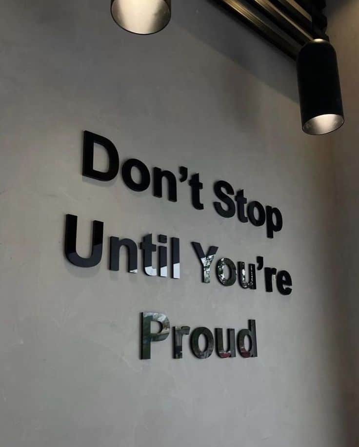 Life is beautiful ✨ Which photo is your favorite_ 1 Motivational quote on wall: Don't Stop Until You're Proud with overhead lighting. Inspiring office decor. - Handy Home Motivational quote on wall: Don't Stop Until You're Proud with overhead lighting. Inspiring office decor.