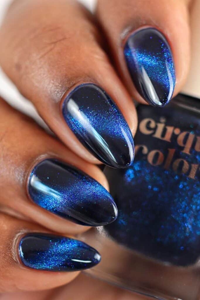 Melody Shimmering deep blue nail polish on manicured nails, showcasing a sleek and glossy finish. Perfect for a bold, elegant look. - Handy Home Shimmering deep blue nail polish on manicured nails, showcasing a sleek and glossy finish. Perfect for a bold, elegant look.