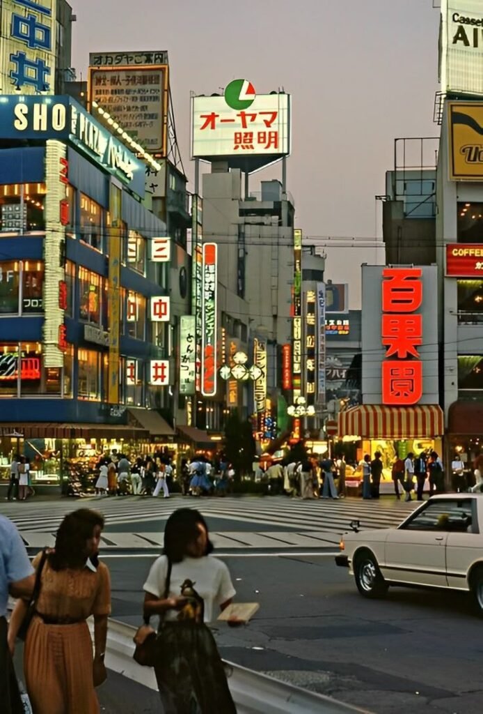 Vibrant Tokyo street scene at dusk, bustling with people and colorful neon signs, showcasing urban life in Japan.
