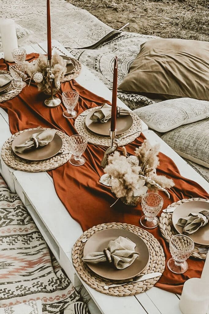 Terracotta Rust Spandex 4-Way Stretch Fabric Roll DIY Craft Fabric Bolt- 60_x10 Yards Rustic picnic setup with woven placemats, brown plates, red candles, and cozy cushions for an outdoor dining experience. - Handy Home Rustic picnic setup with woven placemats, brown plates, red candles, and cozy cushions for an outdoor dining experience.